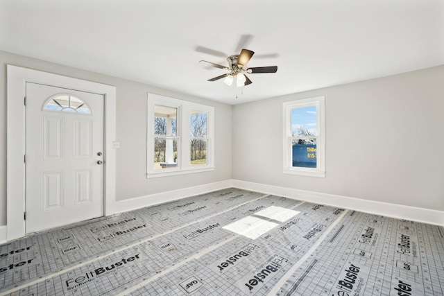 entryway with tile patterned floors, baseboards, plenty of natural light, and ceiling fan