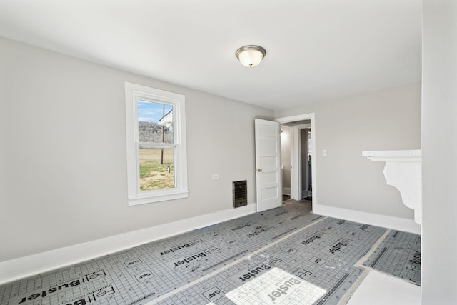 unfurnished room with tile patterned floors, visible vents, and baseboards