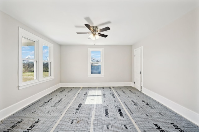 empty room with baseboards and a ceiling fan