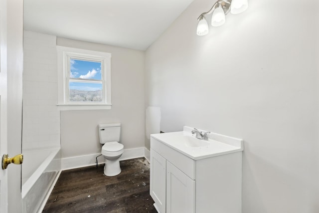 full bathroom with baseboards, toilet, wood finished floors, and vanity