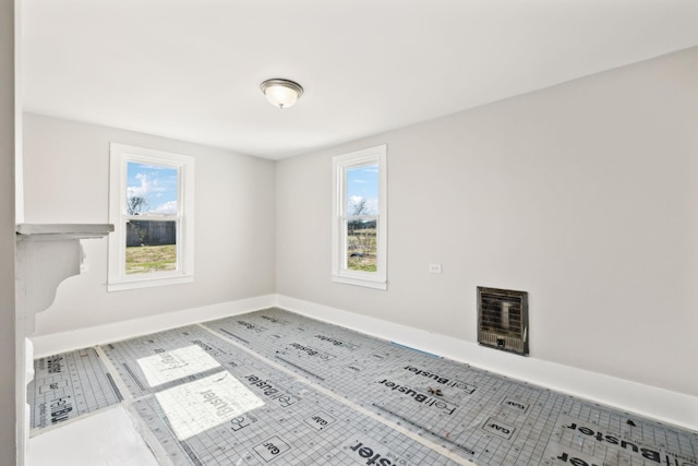 unfurnished room with a wealth of natural light and baseboards