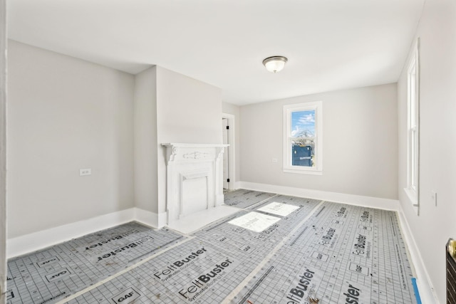 unfurnished living room featuring tile patterned floors and baseboards