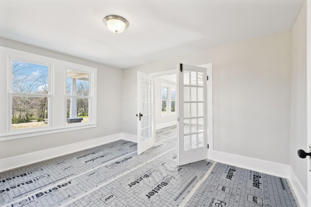 foyer featuring light tile patterned flooring, french doors, and baseboards