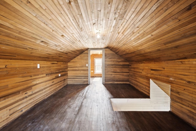 bonus room featuring dark wood finished floors, wooden walls, wood ceiling, and lofted ceiling