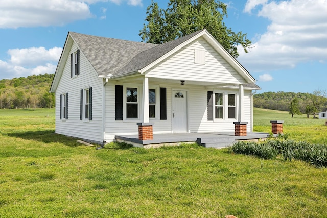 57 Young Branch Rd, Dixon Springs, TN 37057 - bungalow-style house with a shingled roof, a front yard, and covered porch