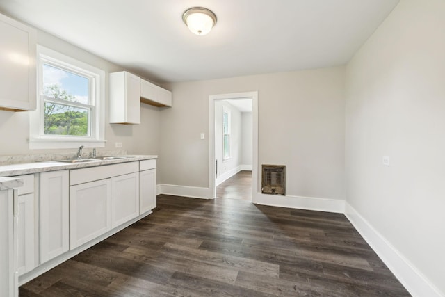 57 Young Branch Rd, Dixon Springs, TN 37057 - kitchen with heating unit, a sink, white cabinets, baseboards, and dark wood-type flooring