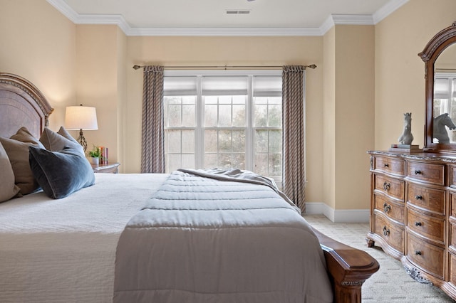 bedroom featuring visible vents, baseboards, light colored carpet, and ornamental molding