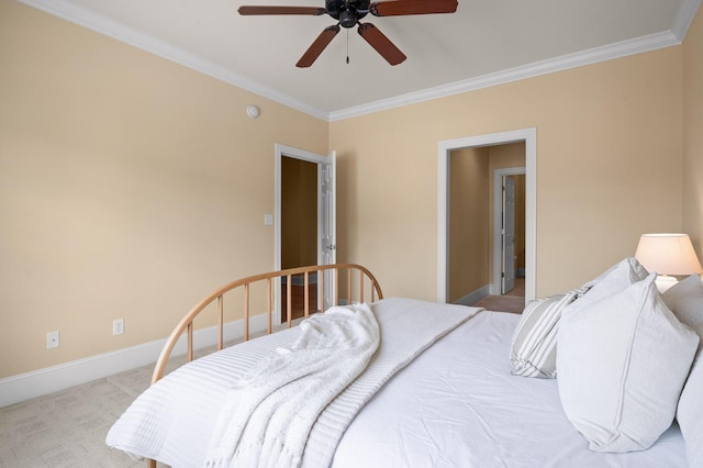 carpeted bedroom with ceiling fan, baseboards, and ornamental molding