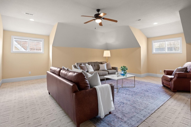 living area with visible vents, baseboards, lofted ceiling, and a ceiling fan