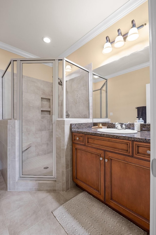 bathroom with vanity, crown molding, tile patterned floors, and a shower stall