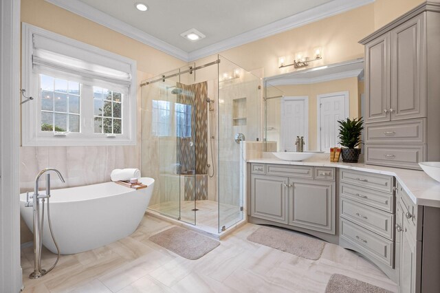 bathroom featuring vanity, a soaking tub, a stall shower, and ornamental molding