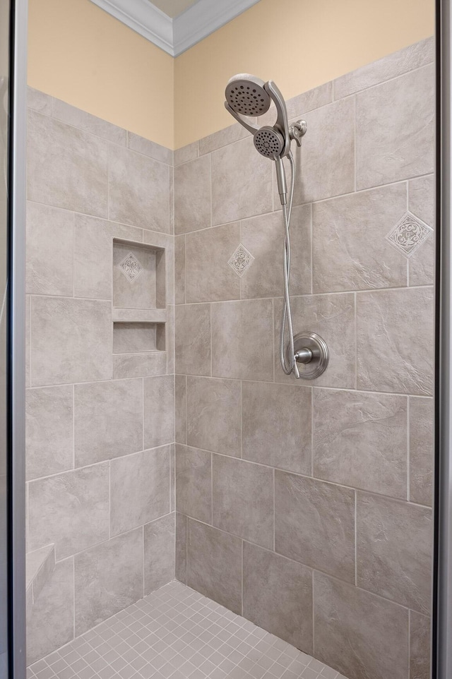 full bathroom featuring crown molding and tiled shower