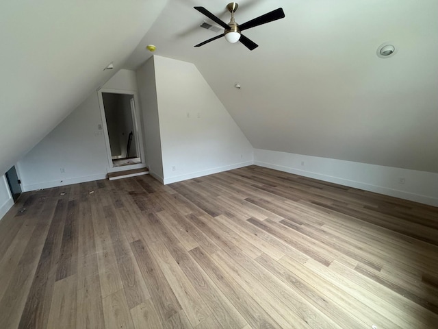 bonus room featuring vaulted ceiling, visible vents, ceiling fan, and wood finished floors