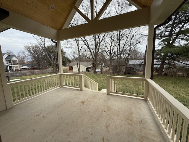 deck featuring a residential view, a patio, a yard, and fence