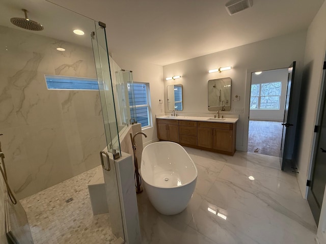 full bath with a marble finish shower, double vanity, a soaking tub, marble finish floor, and a sink