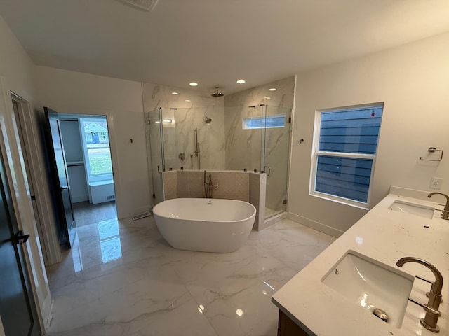 full bath featuring double vanity, marble finish floor, and a sink