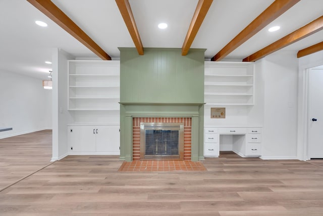 unfurnished living room featuring light wood-style flooring, a fireplace, and baseboards