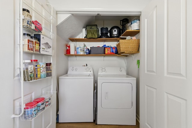 washroom with laundry area, independent washer and dryer, and wood finished floors