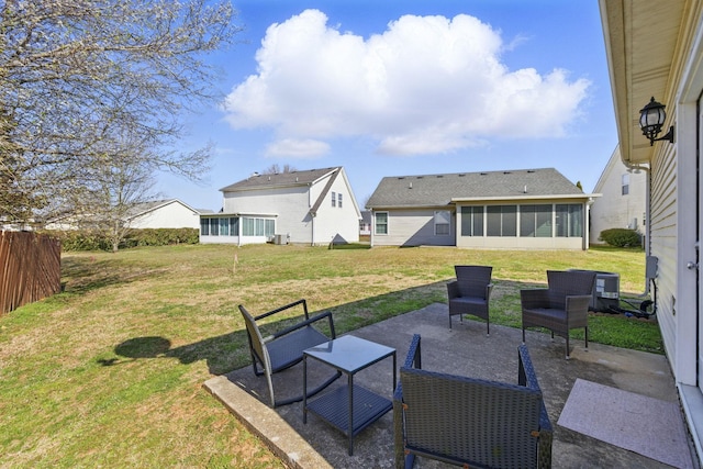 view of yard with fence, a patio, and a sunroom