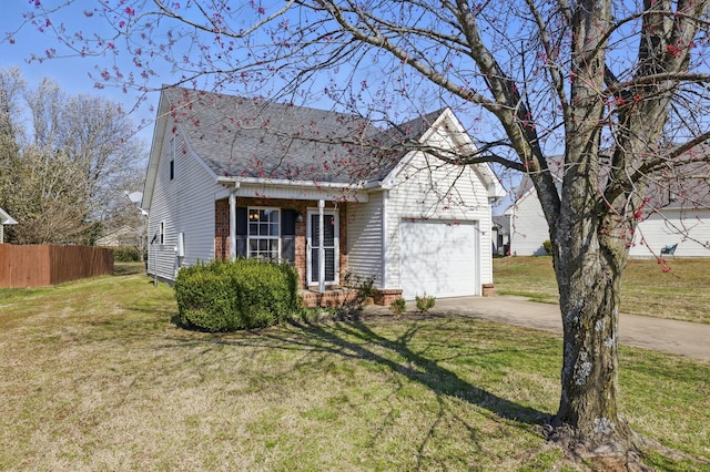 view of front of home with driveway, an attached garage, a front yard, and fence