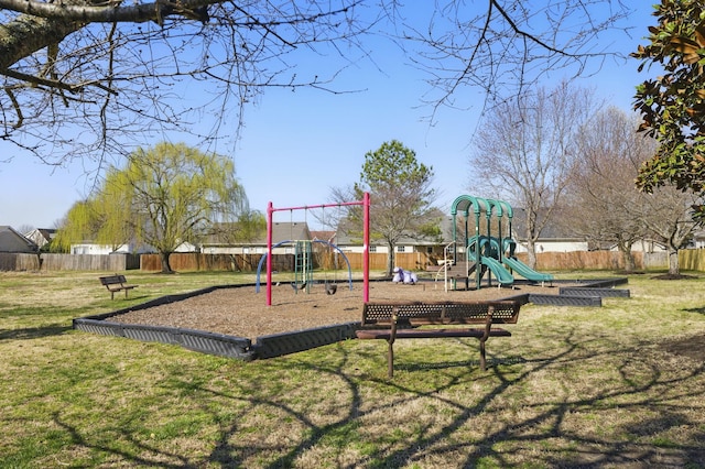 community playground featuring a yard and fence