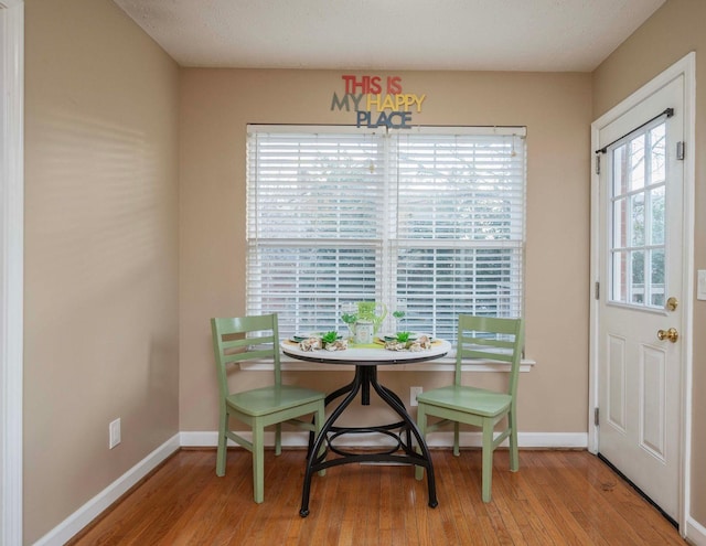 dining area featuring baseboards and wood finished floors