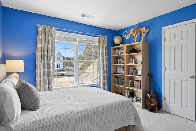 carpeted bedroom with visible vents