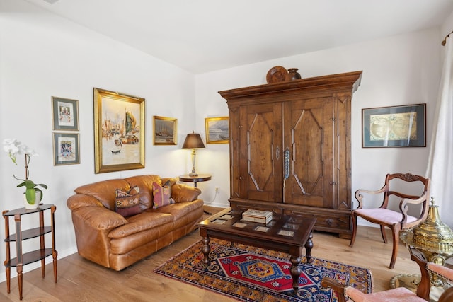 living area with wood finished floors and baseboards