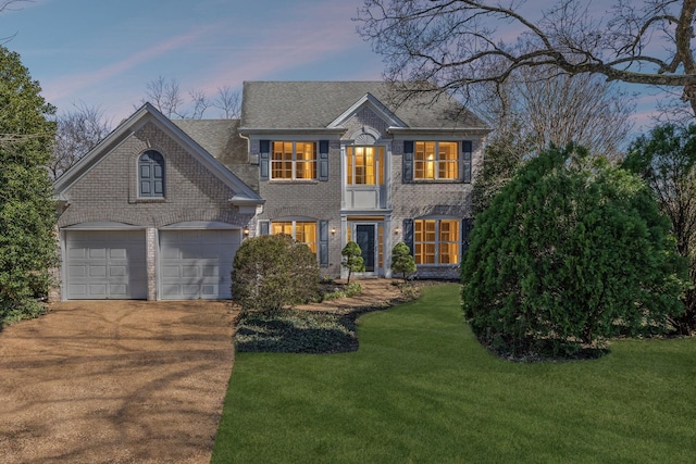 view of front of house featuring brick siding, concrete driveway, and a front lawn