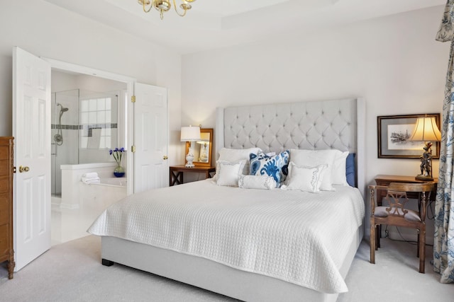 bedroom with a notable chandelier, carpet, and ensuite bathroom