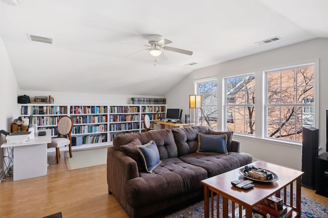 living room featuring visible vents, light wood-style floors, ceiling fan, and vaulted ceiling