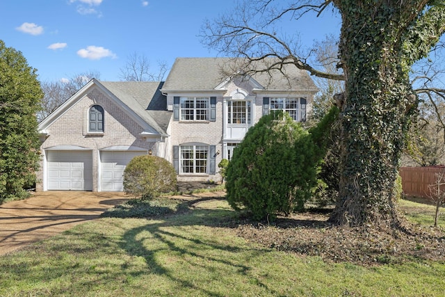 view of front of home featuring fence, concrete driveway, a front yard, a shingled roof, and brick siding