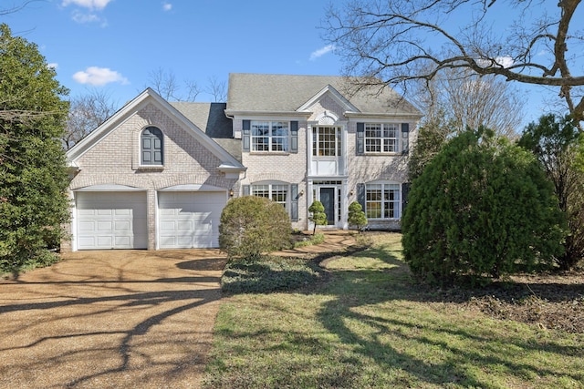 view of front of home with brick siding, a shingled roof, a front lawn, a garage, and driveway