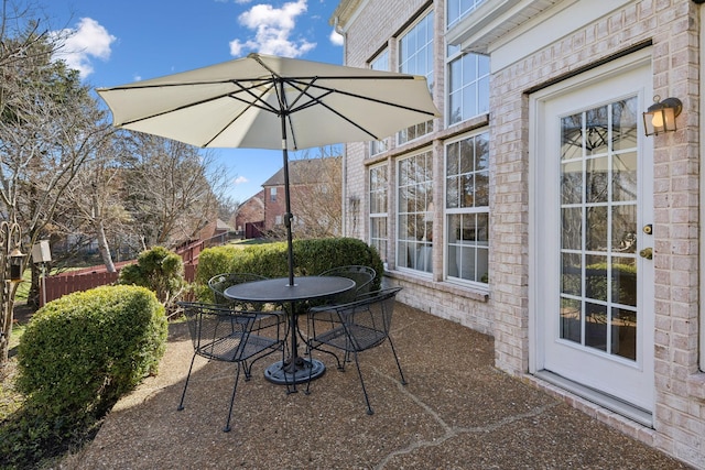 view of patio / terrace featuring outdoor dining area and fence