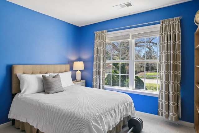 bedroom featuring baseboards, visible vents, and carpet floors