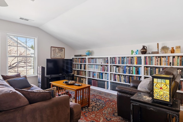 living room featuring lofted ceiling and visible vents