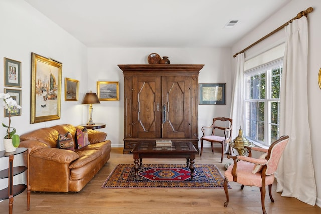 sitting room with visible vents and wood finished floors