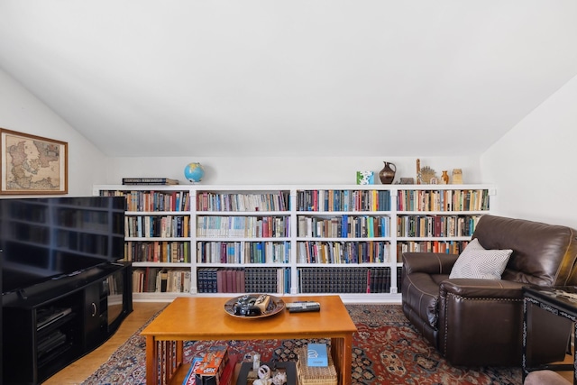 sitting room with lofted ceiling and wood finished floors