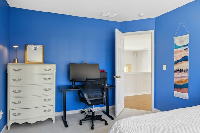 carpeted bedroom with visible vents and baseboards