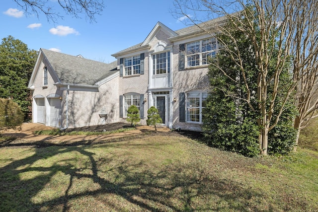 view of front of home featuring a garage, brick siding, a front lawn, and a shingled roof