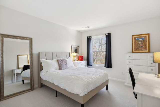 bedroom with baseboards, visible vents, and light carpet