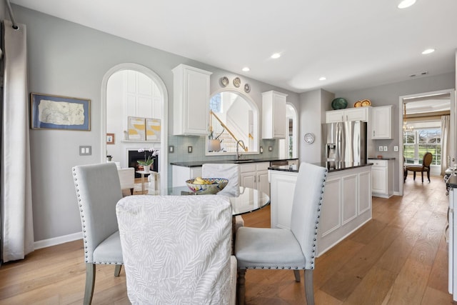 dining area featuring recessed lighting, light wood-style flooring, visible vents, and baseboards