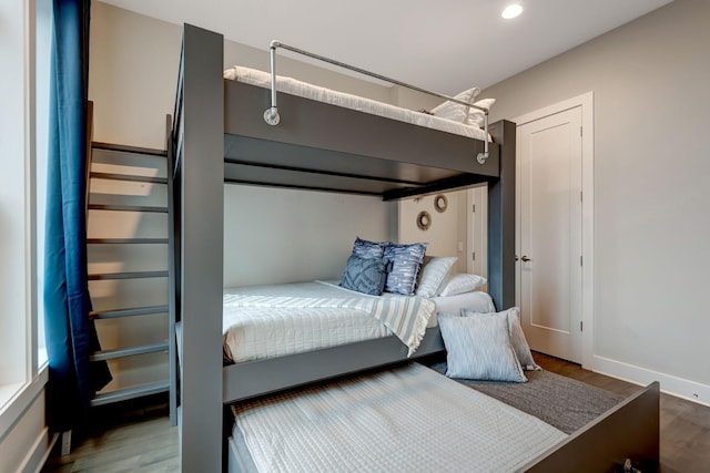 bedroom with recessed lighting, baseboards, and wood finished floors