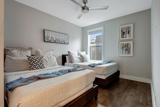 bedroom with dark wood finished floors, baseboards, and ceiling fan