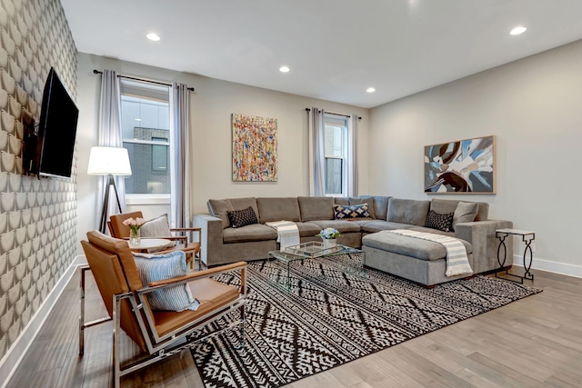 living room with recessed lighting, baseboards, and wood finished floors