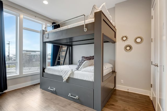 bedroom with baseboards and wood finished floors