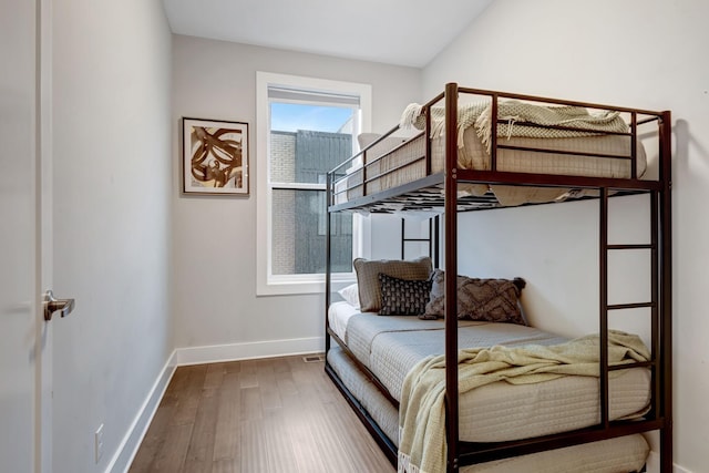 bedroom featuring wood finished floors and baseboards