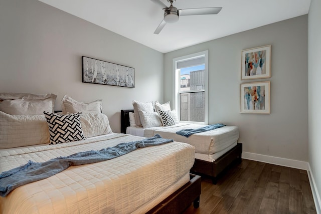 bedroom featuring baseboards, dark wood-style flooring, and ceiling fan