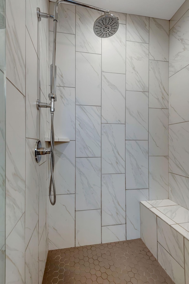 bathroom with tiled shower