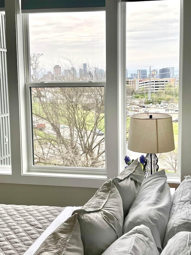 bedroom featuring a city view